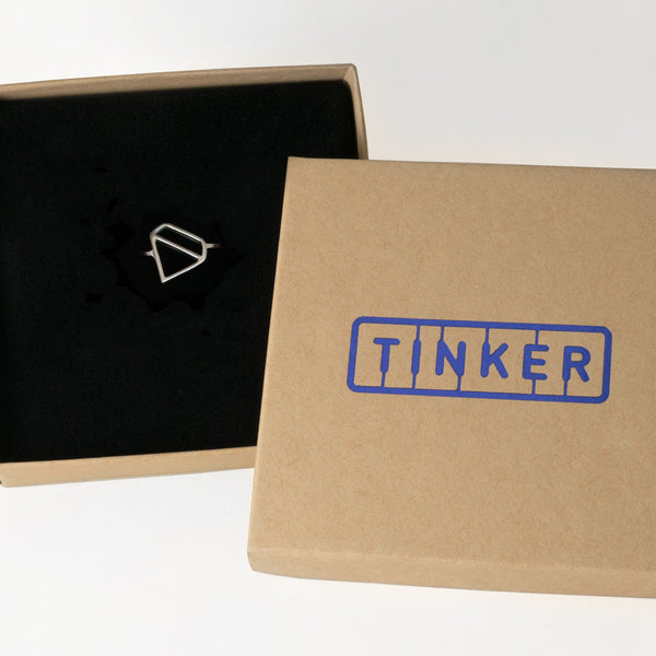 Ice Diamond Ring with an outline of a faceted gemstone shape, from a collection of fun and playful symbolic jewelry by Tinker Company. Shown here in a Tinker gift box.