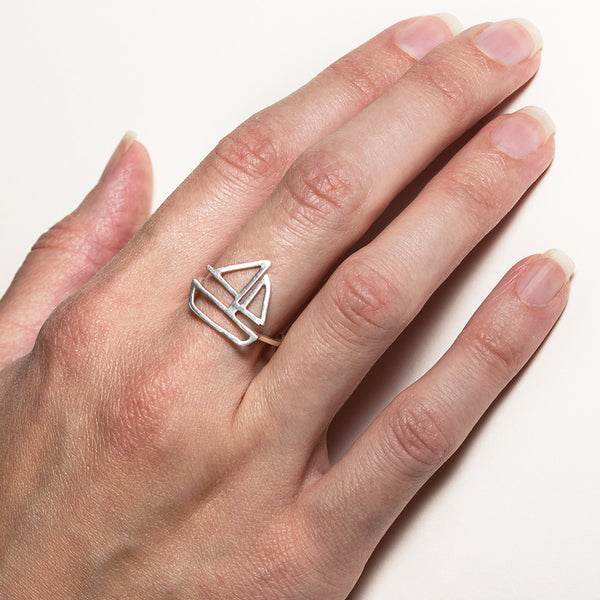Sailboat Ring in sterling silver, as shown on model's hand. From a collection of fun and playful nautical jewelry by Tinker Company.