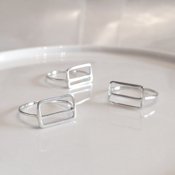A group of sterling silver Metrocard Rings shown at various angles.