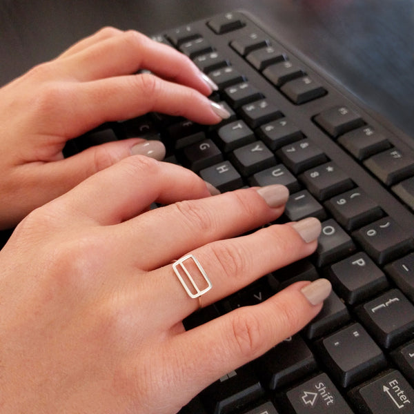 Metrocard Ring shown here on a model's hand while typing on a keyboard.
