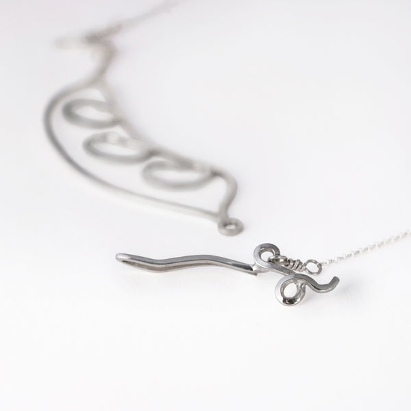 Detail of Bean Pod Necklace with Three Beans showing the peapod tendril clasp and chain. From a collection of fun and playful kinetic jewelry.