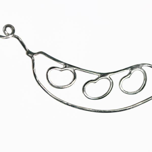 Detail of Bean Pod Necklace with Three Beans showing the beans and curling tendril and the top. From a collection of fun and playful kinetic silver bean jewelry.