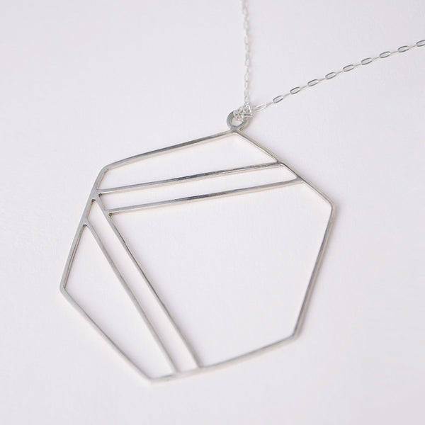 Sterling silver necklace with hexagonal shape outline and center stripe design