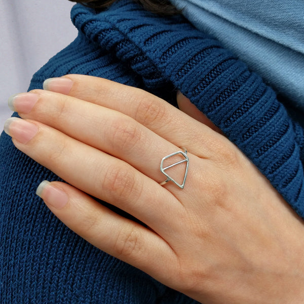 Model wears the silver Ice Diamond Ring with an outline of a faceted gemstone shape based on a minimalist illustration. From a collection of fun and playful symbolic jewelry by Tinker Company.