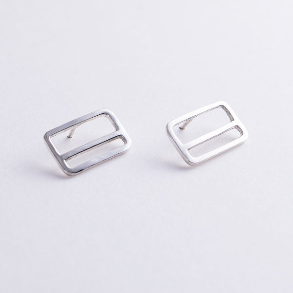 Tinker Company's silver rectangle earrings with a horizontal stripe, design inspired by the NYC Metrocard.