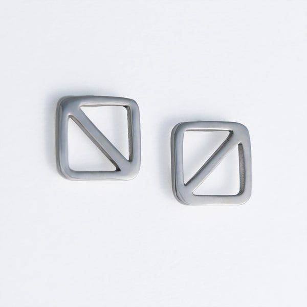Geometric nautical earrings in a square shape with a diagonal line, the design inspired by the letter "O" nautical flag which is the signal flag for "man overboard!" Part of a collection of fun and playful nautical jewelry by Tinker Company.