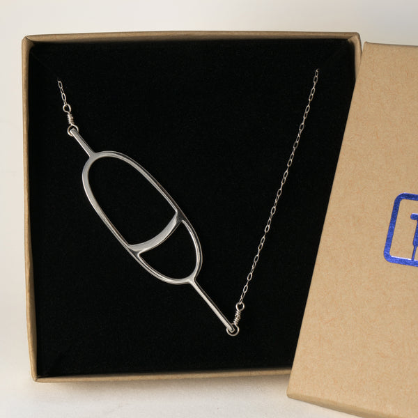 Oval Nautical Buoy Pendant with Stripe shown in a Tinker Company gift box. From a collection of simple storytelling memory jewelry inspired by your favorite memories spent on the water.