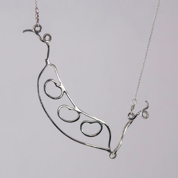 Bean Pod Necklace in sterling silver with three beans, shown in an alternate position