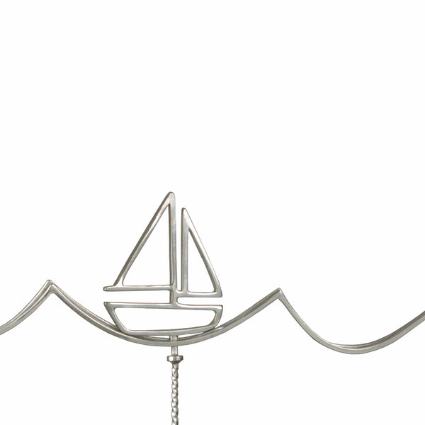 Detail of the Sailboat Necklace with a moving boat from a collection of fun and playful kinetic jewelry by Tinker Company.