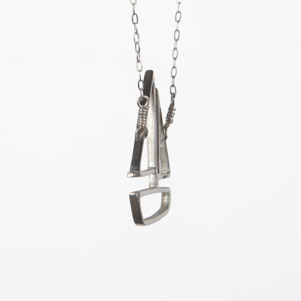 Side view of the Sailboat Pendant in Sterling Silver. From a collection of playful nautical jewelry sustainably made in New York City by Tinker Company.