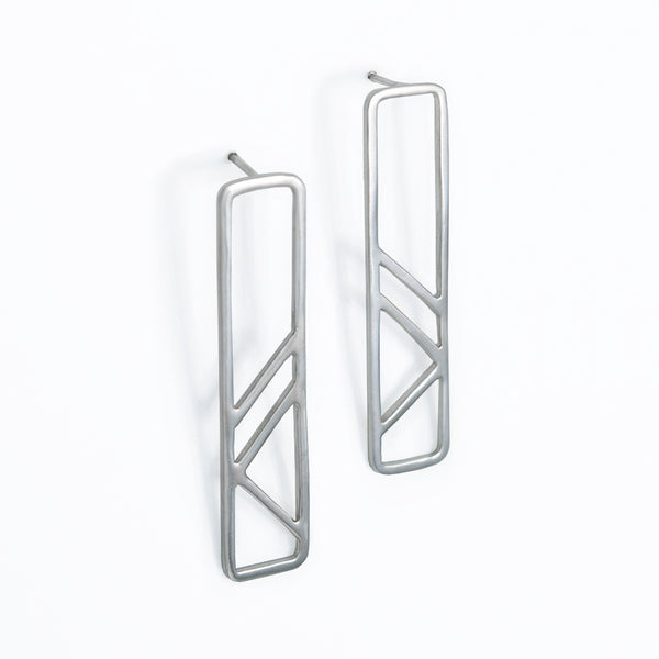 Architectural Pillar Earrings in sterling silver are inspired by the metal column pillars supporting the subway tracks. Part of the City Collection of architectural jewelry by Tinker Company made in NYC.