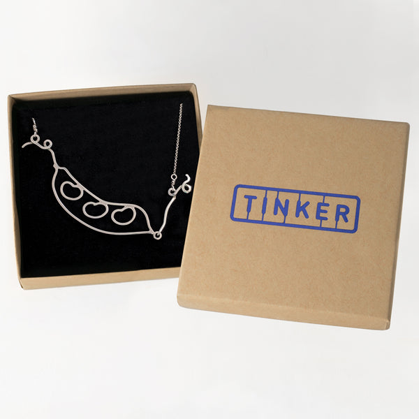 Kinetic Bean Pod Necklace shown in a Tinker Company gift box. This pendant is not just a great gift for gardeners and green thumbs, it's a sentimental piece of jewelry that helps you celebrate all the people in your pod or symbolic garden. Sustainably made in New York.