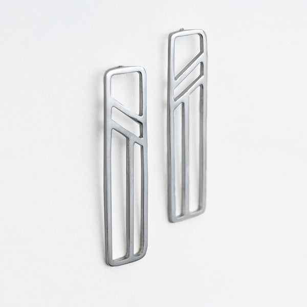 Silver Flying Buttress Earrings, an abstract modern design inspired by angled and linear architectural shapes set inside rectangular outlines.
