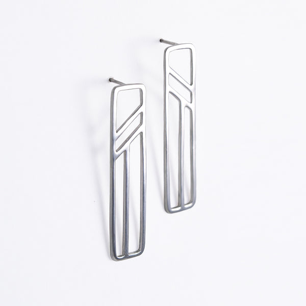 Silver Flying Buttress Earrings, a pair of silver geometric earrings from a collection of abstract architectural jewelry by Tinker Company. Sustainable made in NYC.