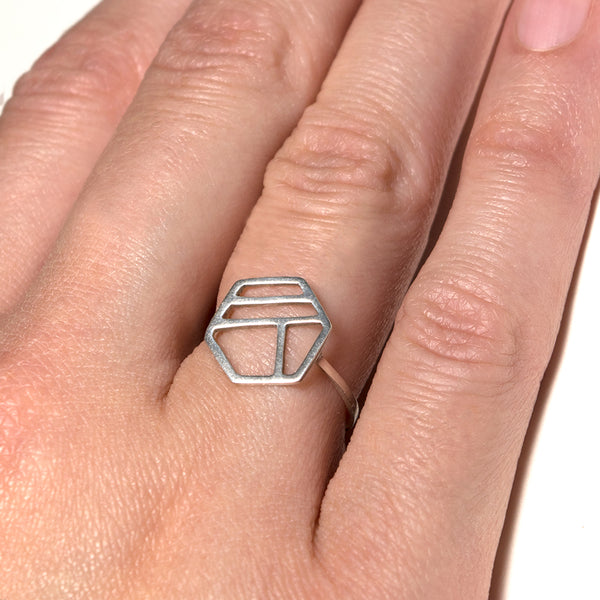 Silver Hexagon Ring with Three Lines shown on a model. Minimalist geometric jewelry with stripes by Tinker Company.