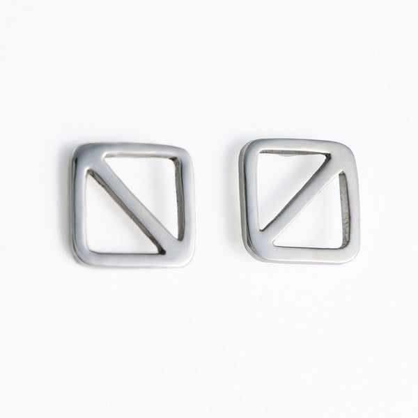 Geometric nautical earrings in a square shape with a diagonal line, the design inspired by the letter "O" nautical flag which is the signal flag for "man overboard!" Part of a collection of fun and playful nautical jewelry by Tinker Company.