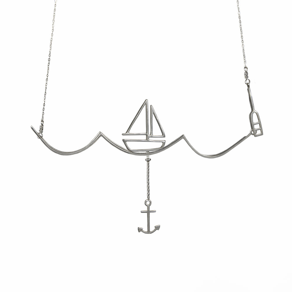 Silver Nautical Necklace with Moving Boat and Anchor on a Wave from a collection of fun and playful kinetic jewelry by Tinker Company.