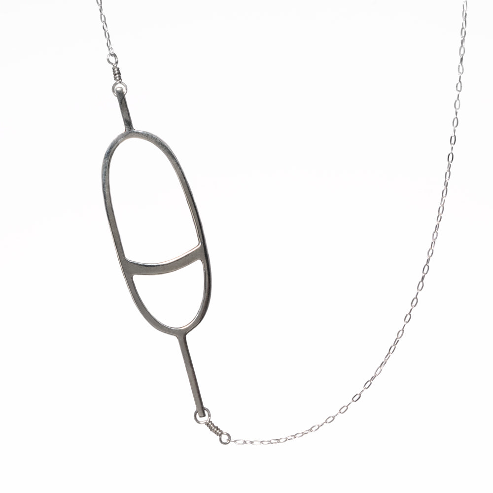 The Oval Nautical Buoy Pendant Necklace in solid sterling silver has a simple minimal oval buoy charm on a delicate chain. From Tinker Company's collection of playful nautical jewelry - sentimental jewelry to remind you of your favorite summer travel and vacation memories on the water.