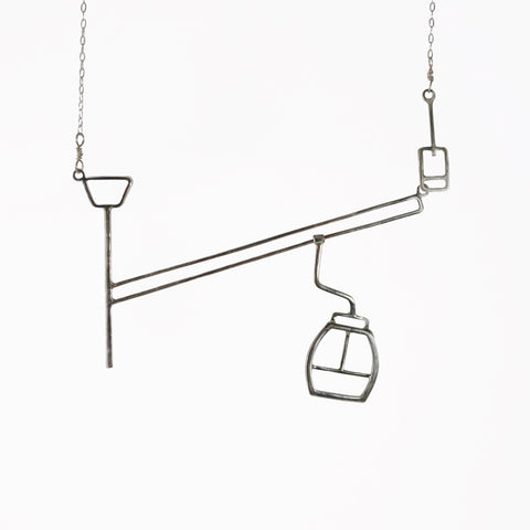 Ski lift necklace with moving gondola on a cable - fun and playful kinetic jewelry by Tinker Company.