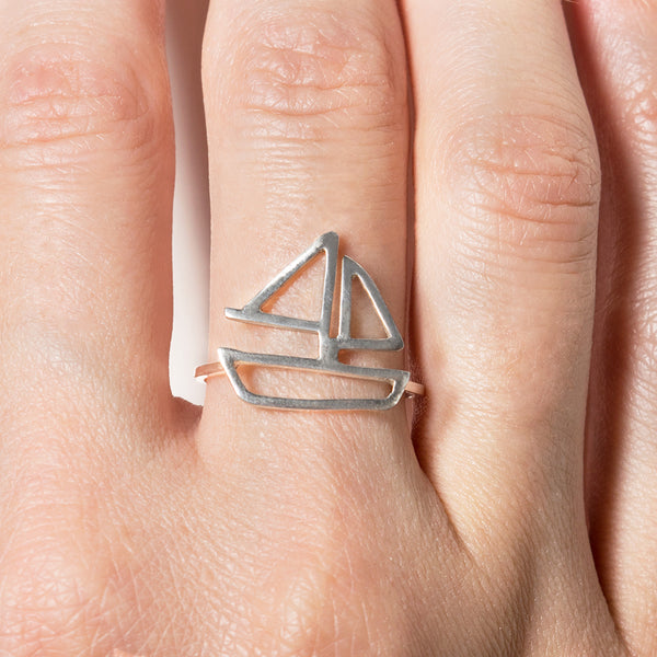 Sailboat Ring in sterling silver, as shown on model's hand. From a collection of fun and playful nautical jewelry by Tinker Company. Sustainably made in New York City.