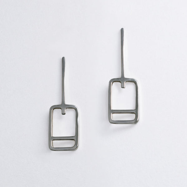 Minimal geometric earrings inspired by the lift tickets at ski resorts. Ski trip memento jewelry designed by Tinker Company.