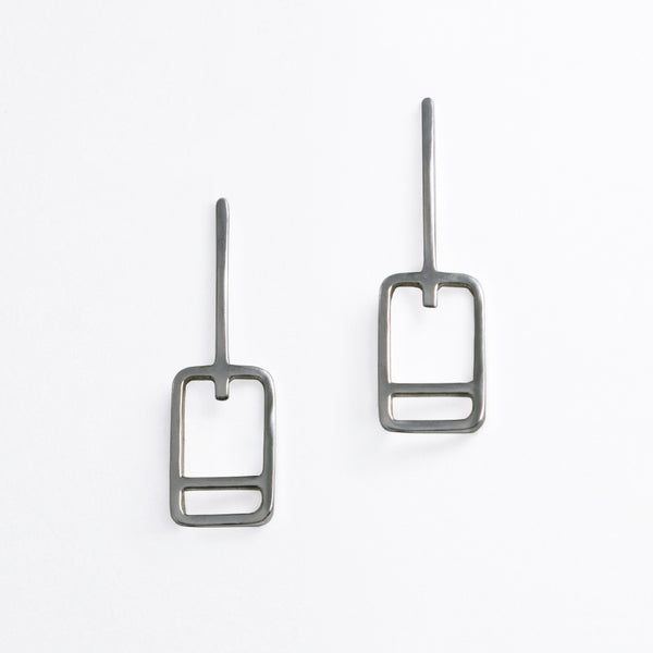 Minimal geometric earrings inspired by the lift tickets at ski resorts. Wear your favorite ski trip memories and feed your winter vacation wanderlust with jewelry designed by Tinker Company.