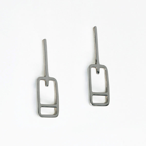 Lift ticket earrings have rectangle shapes with a stripe at the bottom of a line. Designed by Tinker Company, made in recycled sterling silver.