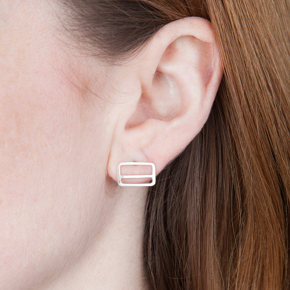 Metrocard Earrings in sterling silver, as shown on model's ear.
