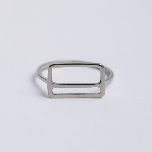 Front view of the Metrocard Ring, the simple design has clean lines with a rectangle outline and an offset horizontal stripe.