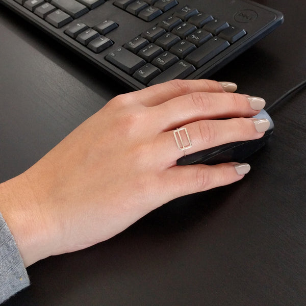 Metrocard Ring shown here on a model's hand while using a computer mouse.