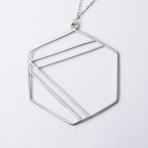 Sterling silver necklace with hexagonal shape outline and center geometric stripe design