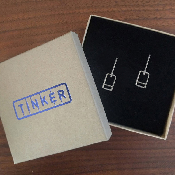 Modern minimal earrings, design inspired by lift tickets, made of recycled sterling silver. Shown here in a Tinker Company box.
